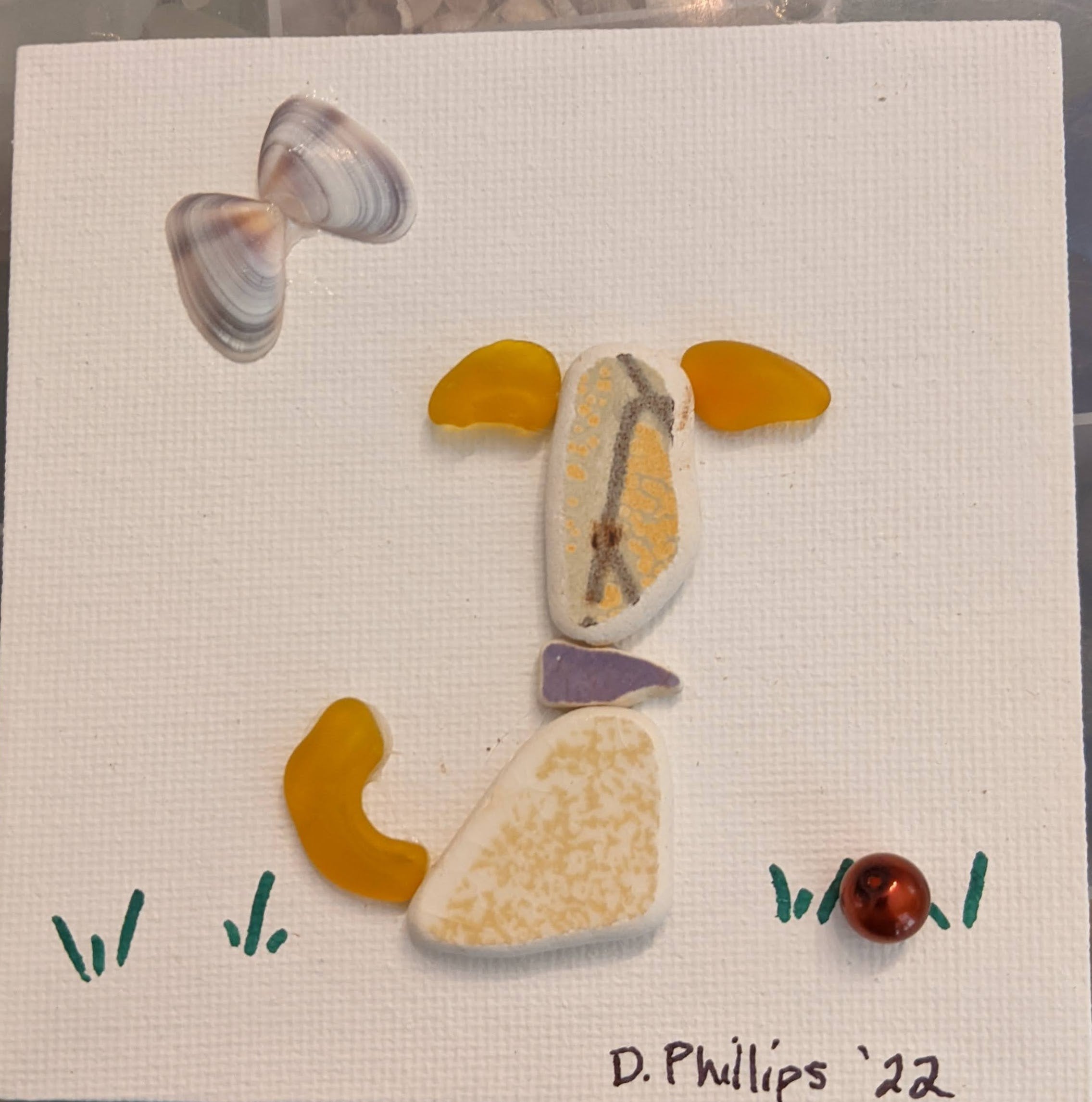 Yellow sea pottery dog with ball and butterfly