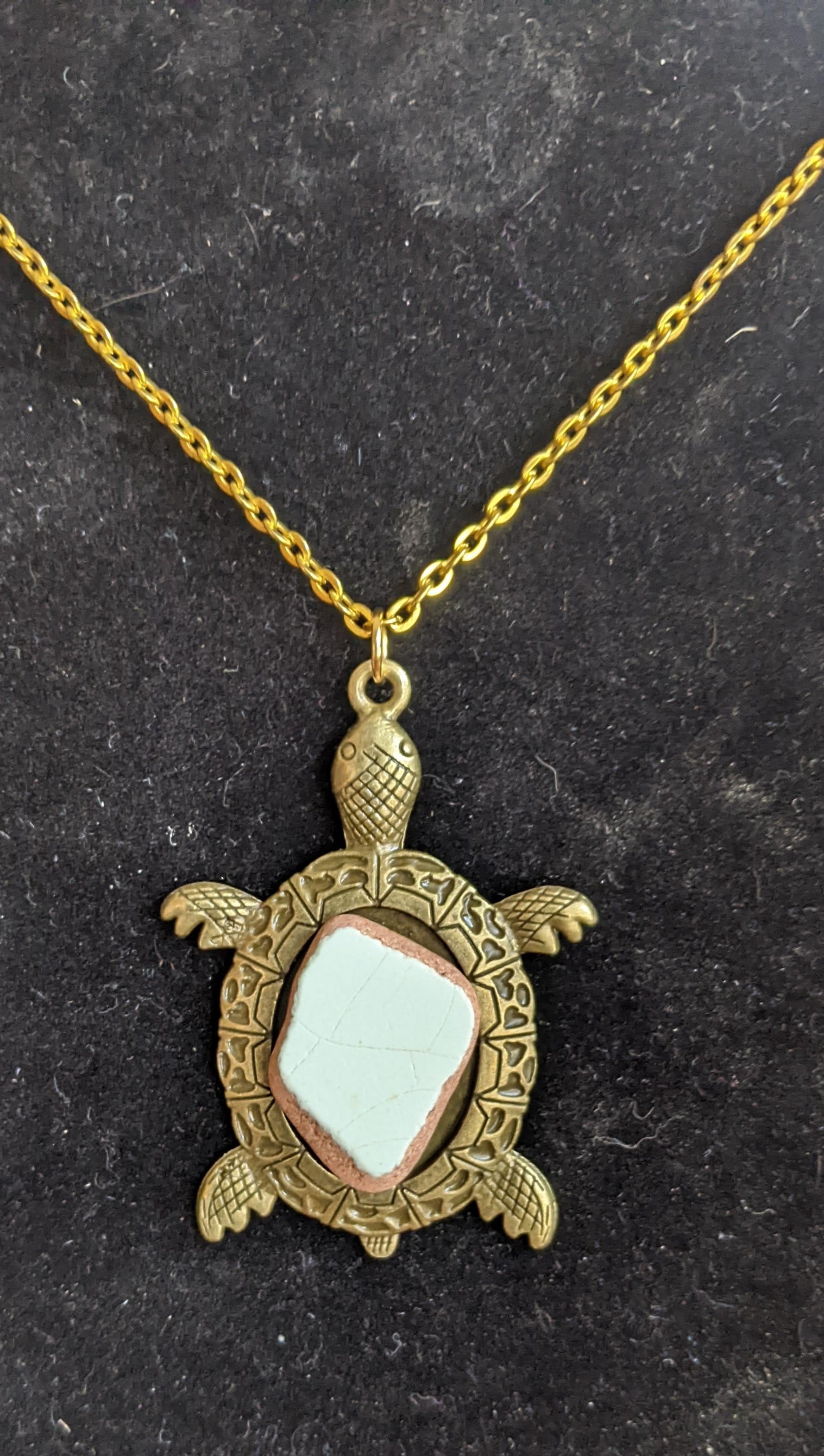 Gold sea turtle with pale blue sea pottery necklace